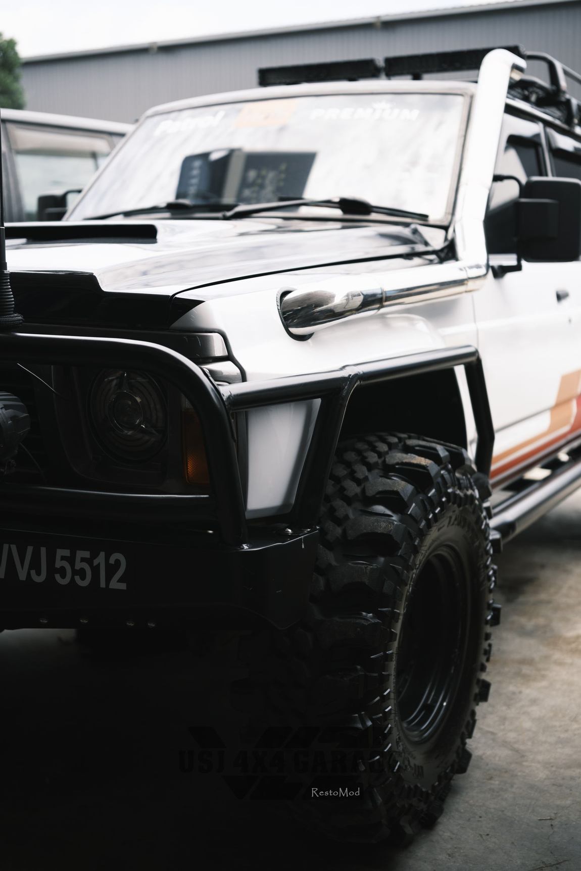 White Nissan Patrol front three-quarter after respray