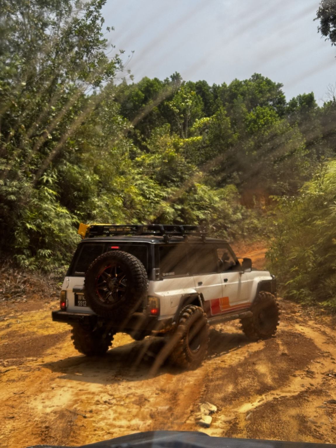 Nissan Patrol on a muddy jungle trail in Pahang