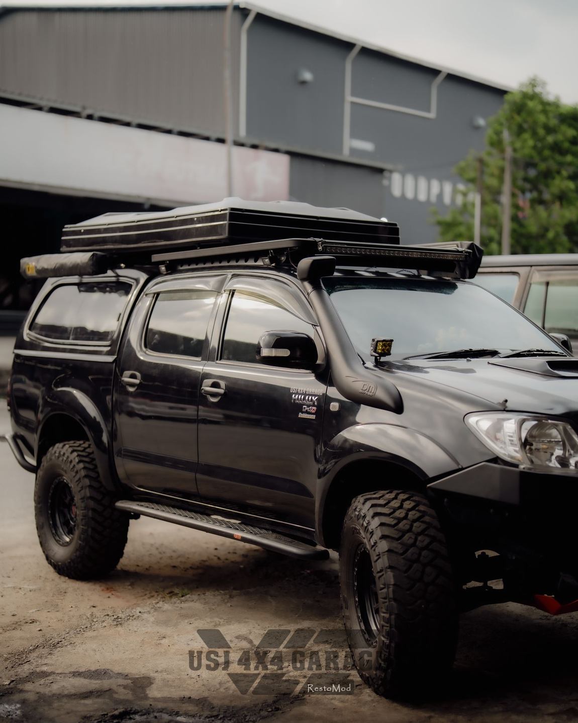 Hilux with roof rack and roof-top tent, side profile